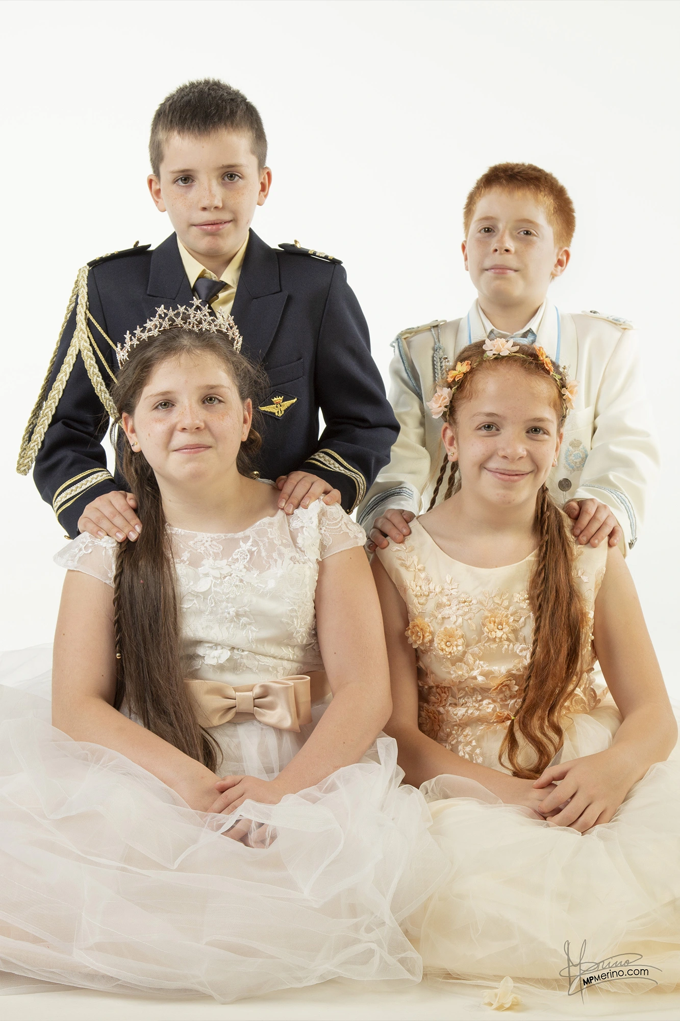 Studio photograph with four children in communion clothes