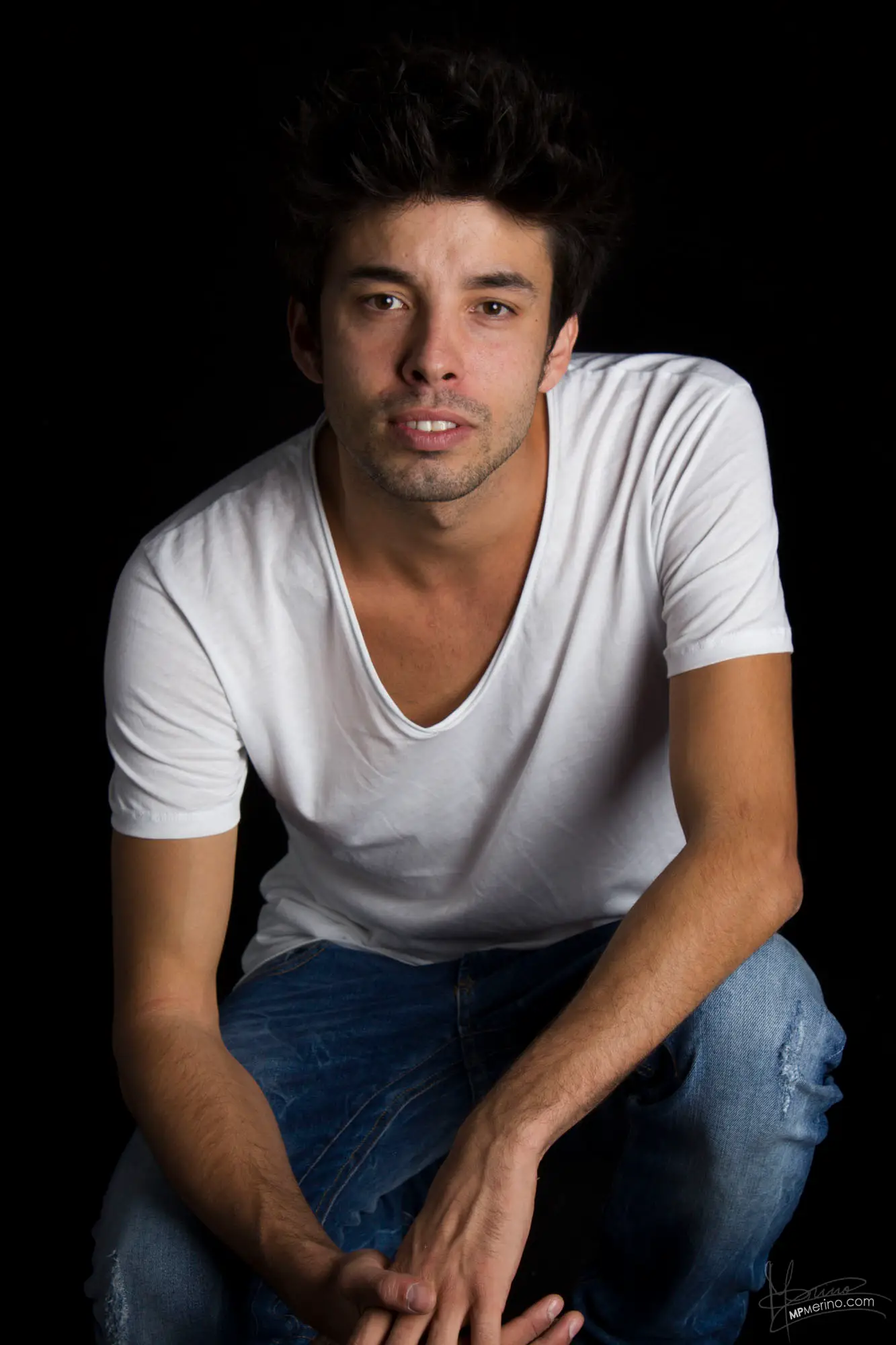 Studio photograph with a squatting boy