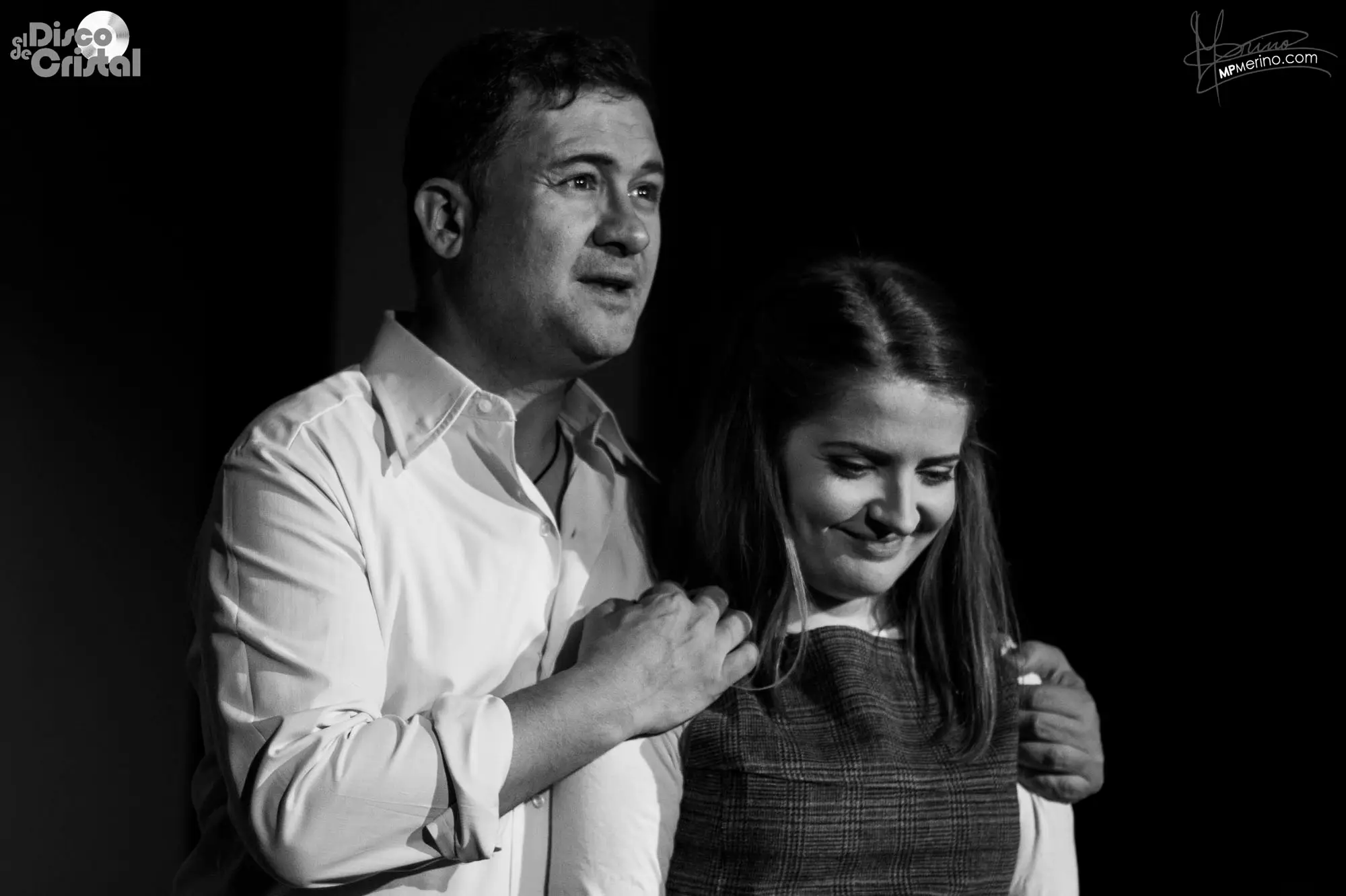 Theatre photograph, an actor holding a young girl by the shoulders and smiling