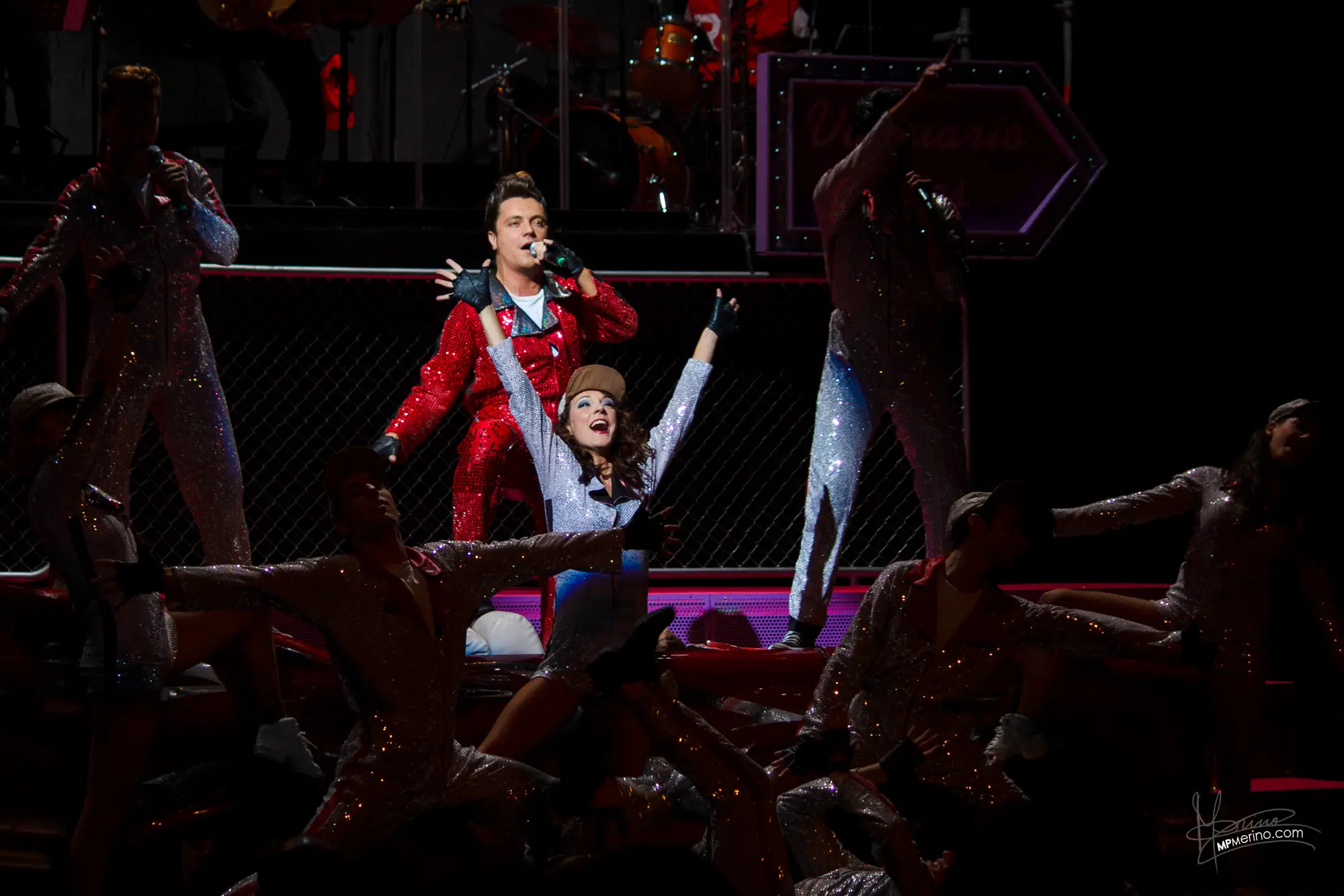 Musical theatre photography, a Grease actor sings surrounded by dancers