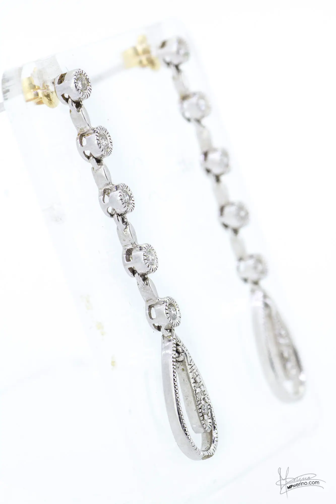 Close-up of white gold earrings