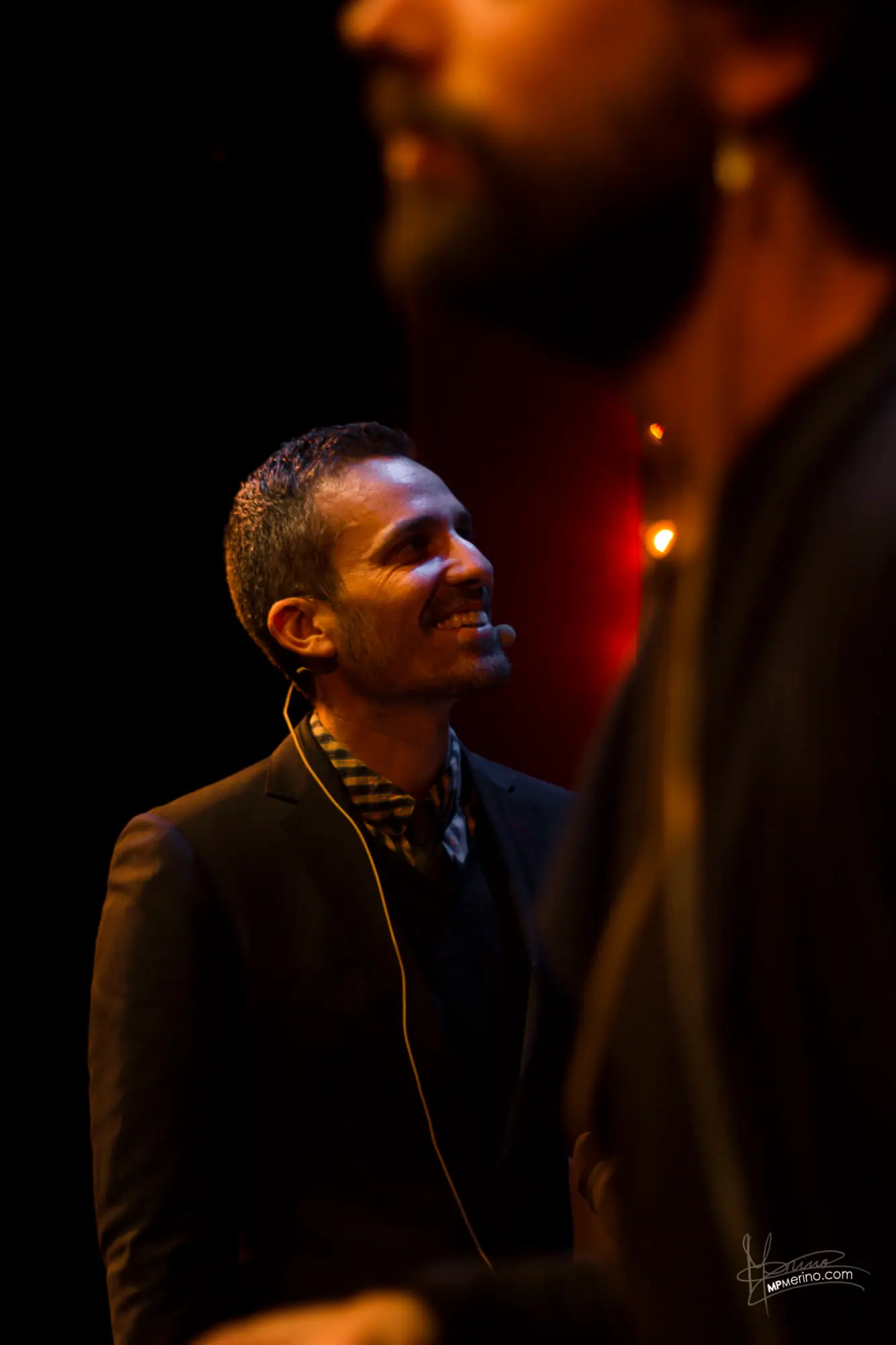 View of an actor looking up with another person blurred in the foreground