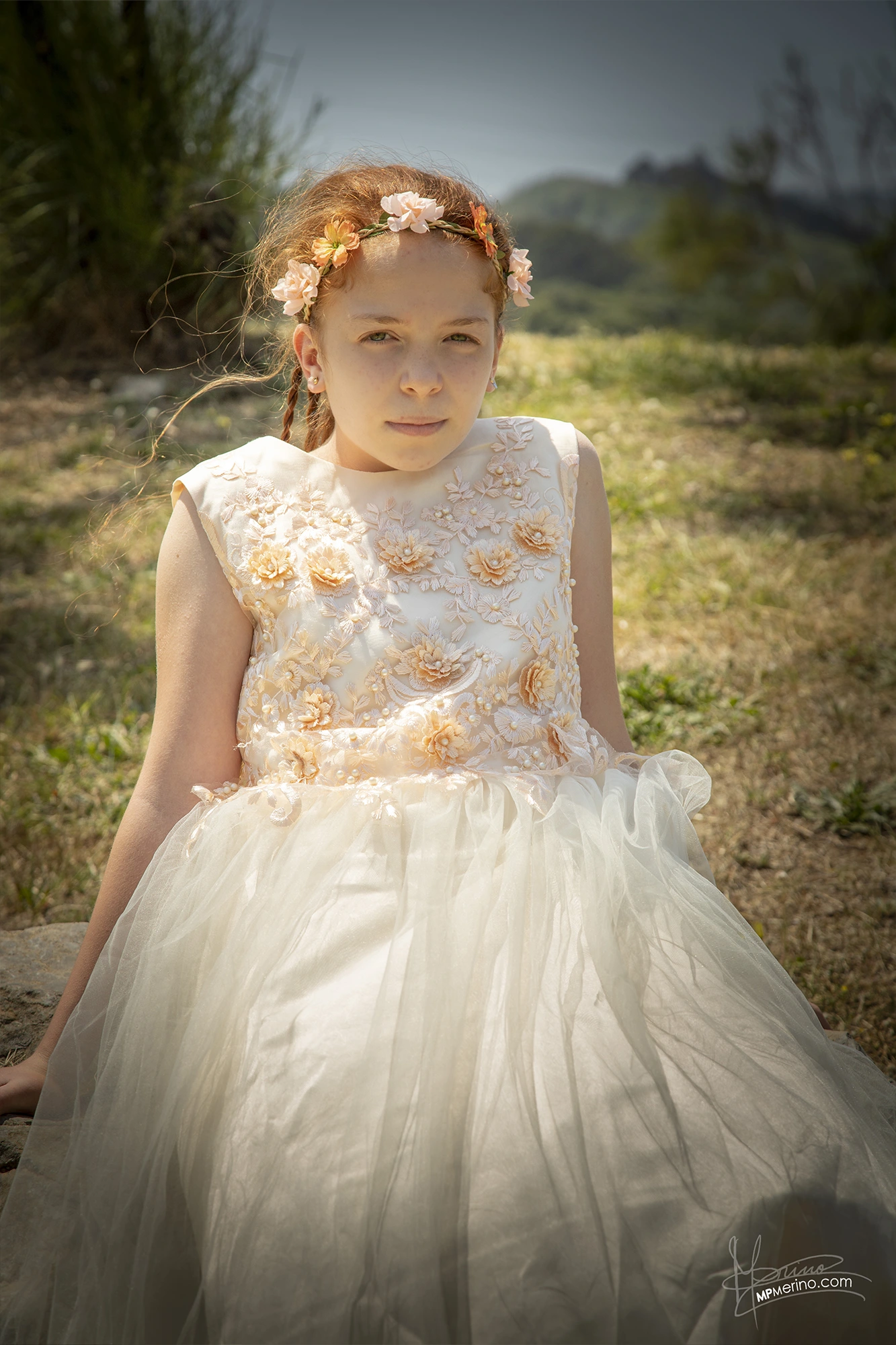 Half-length photograph of a girl looking at the camera in her communion dress